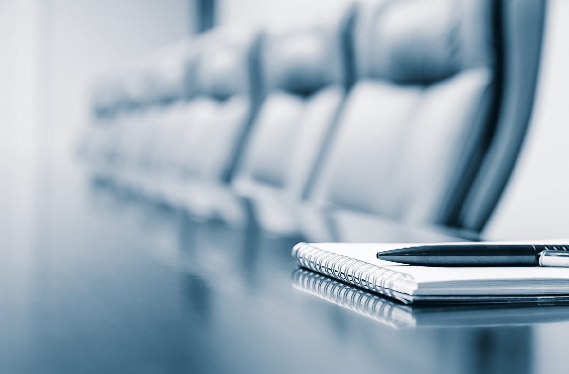 Close-up of a notepod on a desk in a boardroom