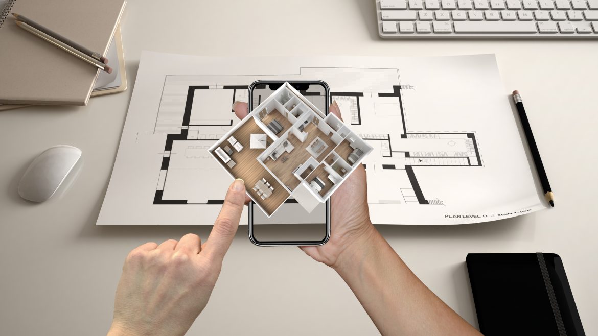 Architect looking at a house design using augmented reality on a mobile phone