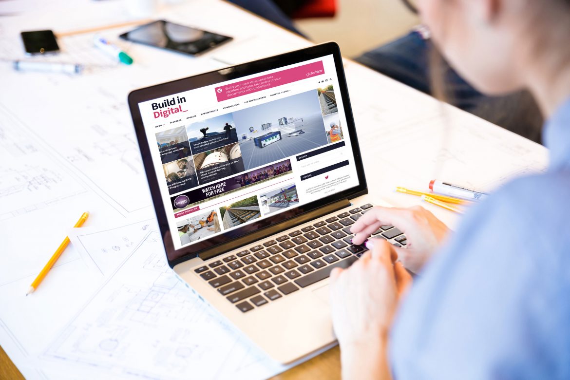 woman using a laptop with Build in Digital graphics on the screen