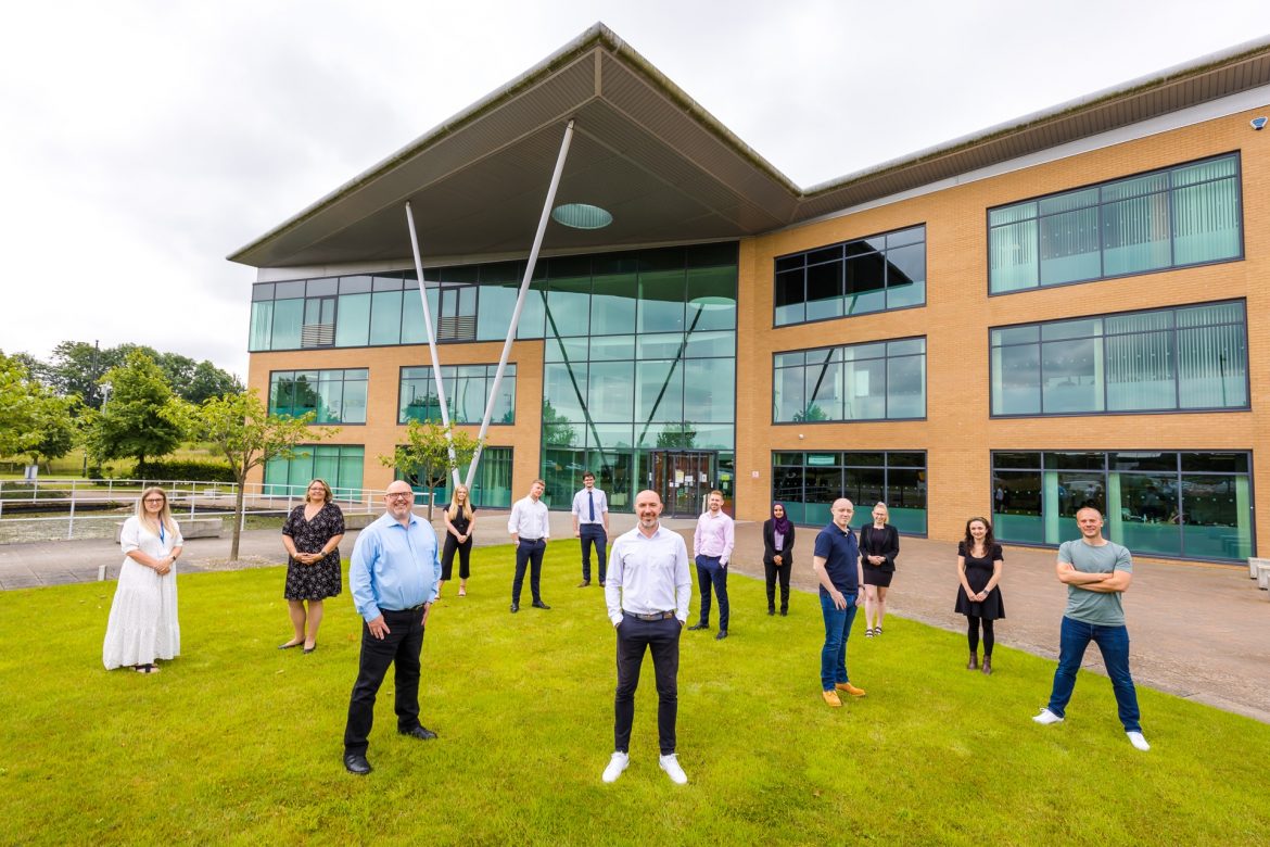 clixifix CEO James Farrell (front centre) with Cllr Graeme Miller (front left) and the clixifix team outside of the Evolve Business Centre