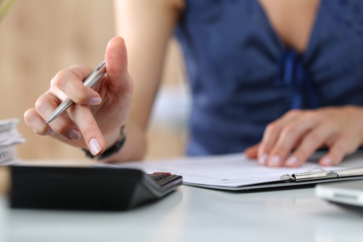 a businesswoman using a calculator