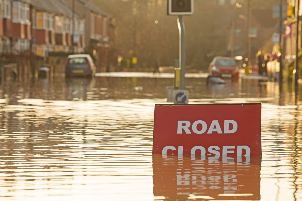 A 'road closed' sign on a flooded road